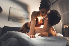 Frau liegt in Dessous auf ihrem Partner