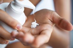Frau gibt eine Lotion auf ihre Handfläche