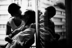 2 Frauen küssen sich am Fenster